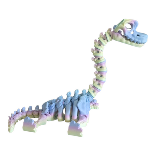 3D printed articulated dinosaur skeleton standing printed in pastel rainbow filament with shades of blue, pink, and green.