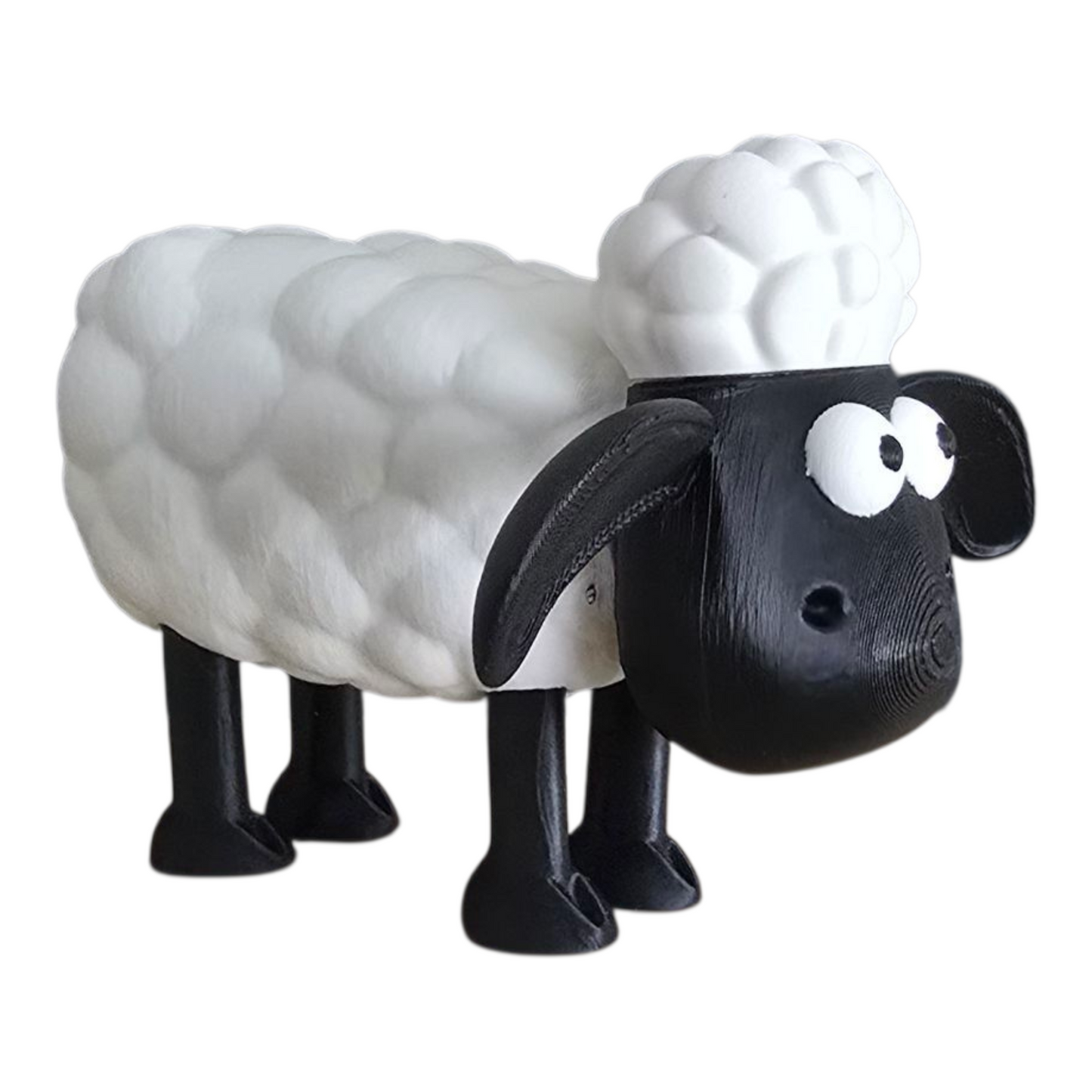 3d printed Sheep-shaped desk toy with black face and legs on a white background. shaun the sheep inspired 3d printing gift.