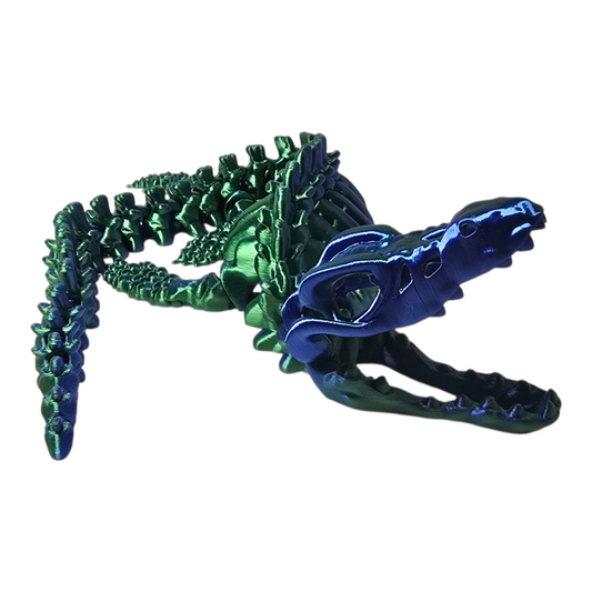 Metallic green and blue alligator figurine on a white background