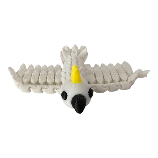 3d printed white cockatoo pocket pal with yellow crest, articulated wings spread on white background