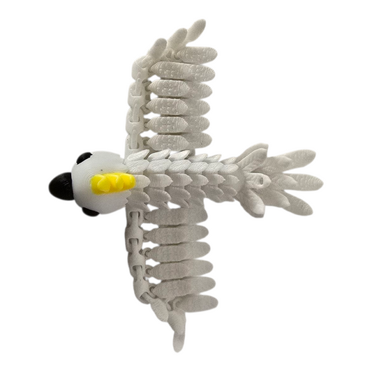 a top down photo of a 3d printed white cockatoo pocket pal with yellow crest, articulated wings spread on white background. 